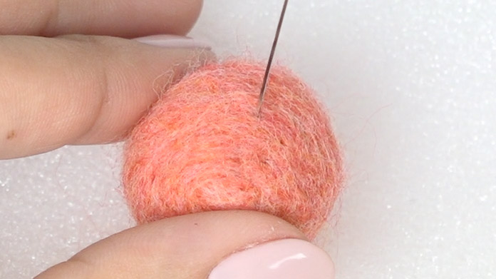 Poke the finishing needle lightly and in a shallow manner.