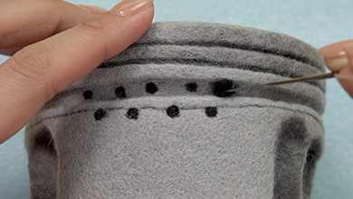 Make balls of black felt and poke so that the holes can be seen from the side