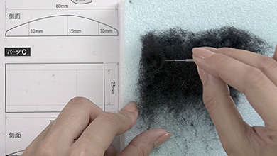 Tear off a piece of black sheet felt one size bigger than pattern C and form the shape while poking with a needle.