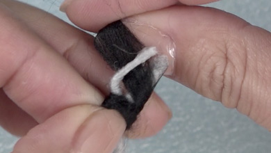 Wrap a black sliver around the join to the end of the grip and poke lightly with a needle.