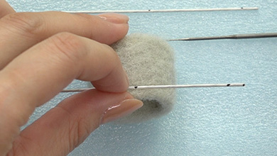 ワイヤー中央の印部分をパーツGの縁に羊毛で刺し付ける
