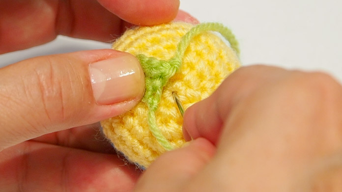 Use the wool end from the part to attach to the ball.