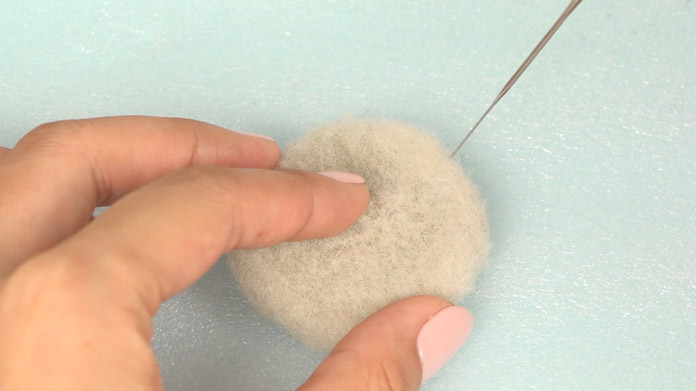 Correct the size by poking towards the centre with the needle.