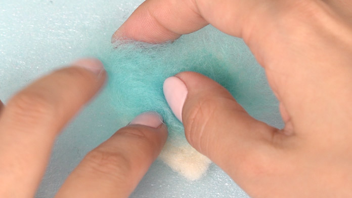 Poke until the surface is covered with the coloured wool.